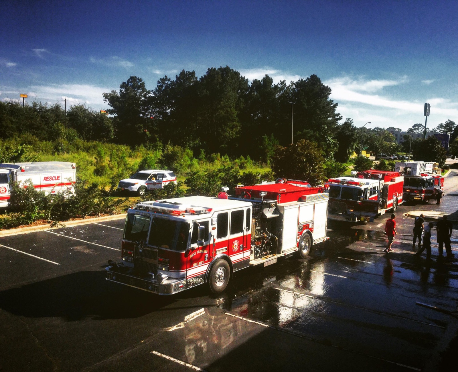 West Florence Fire-Rescue engines and rescue unit staged in a parking lot